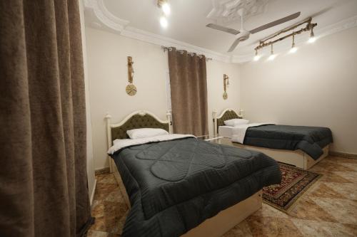 a bedroom with two beds in a room at ABo ZAIN HOSTEL in Aswan
