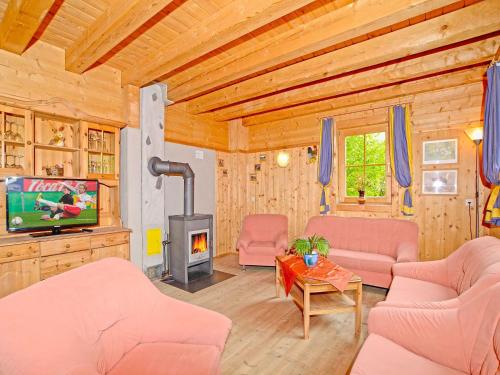 a living room with a fireplace in a wooden house at Chalet mit Sauna und Kamin A 257.001 in Stumm