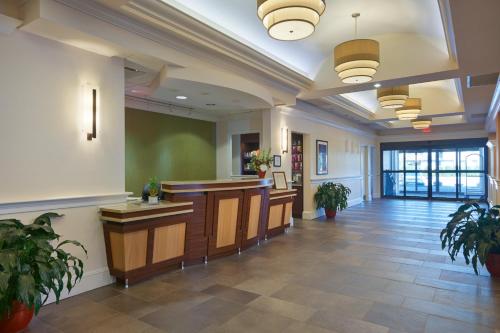 a lobby of a hospital with desks and potted plants at Penn Wells Lodge in Wellsboro