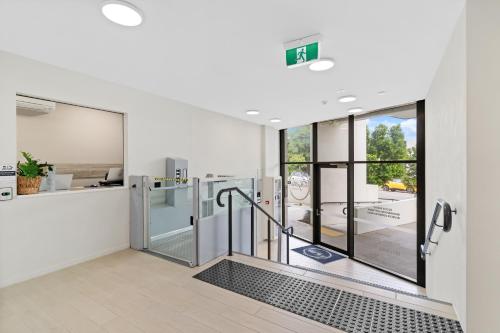 an empty room with a revolving door in a building at Direct Collective - Rhythm on Beach in Maroochydore