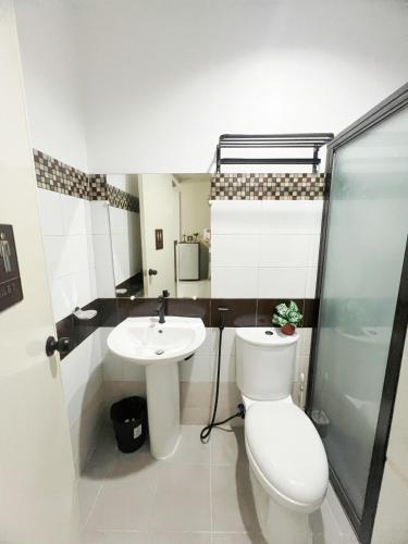 a bathroom with a toilet and a sink at Eusel's Place Butuan in Butuan