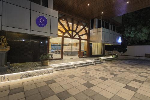 a lobby of a building with a tile floor at Hotel Nivaara By VYDA in Tirupati