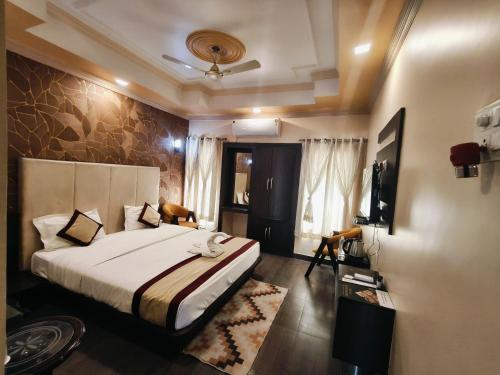 a hotel room with a bed and a television at Hotel The Siwan International in Siwān