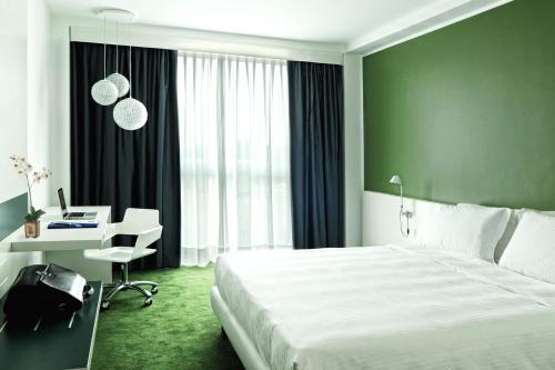 A bed or beds in a room at Idea Hotel Milano Malpensa Airport