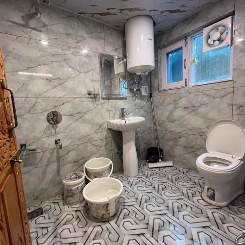 a bathroom with a sink and a toilet at Ilhaan Resort Sonamarg in Sonāmarg