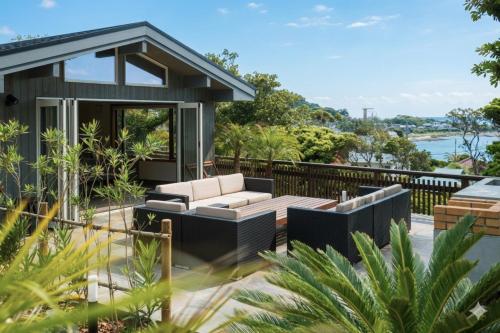 a house with a view of the water at Monterey House by SANA in Tateyama