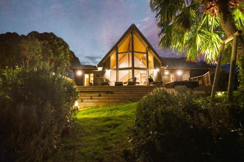 a house lit up at night with lights at Monterey House by SANA in Tateyama