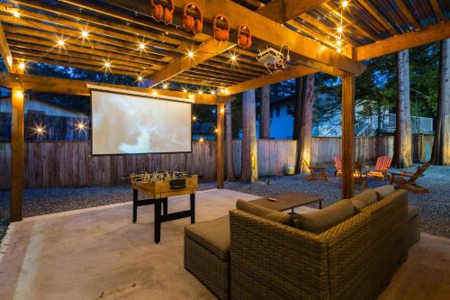 a living room with two couches and a projection screen at Bunny Bliss - Lower Level HotTub FirePit Theatre in Langley