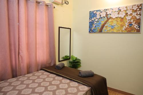 a bedroom with a bed and a mirror at Villa LOR in Pondicherry