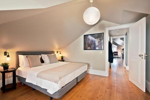 a bedroom with a large bed and a hallway at Lisbon Five Stars Apartments Bica in Lisbon