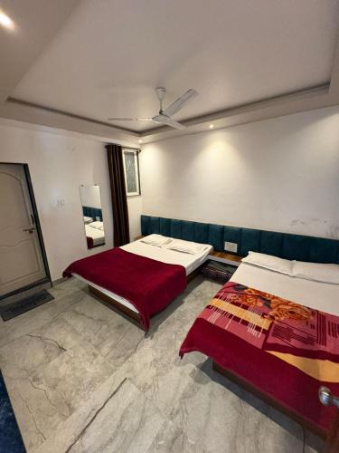 a hotel room with two beds at Chavan guest house in Akalkot