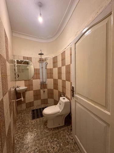 a bathroom with a toilet and a sink at Studio with Sauna & Massage in Kampala
