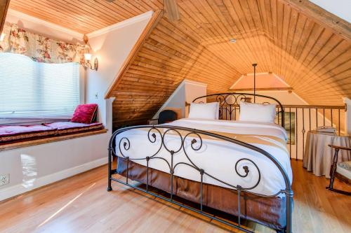 a bed in a room with a wooden ceiling at Quality Inn Creekside - Downtown Gatlinburg in Gatlinburg