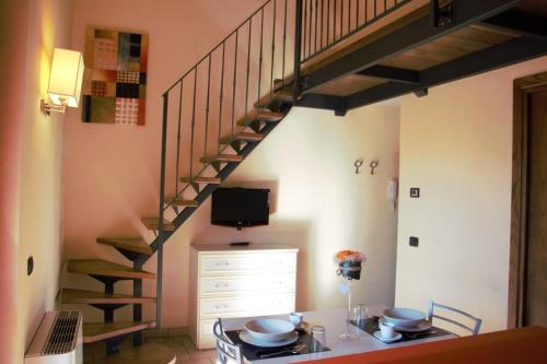 a kitchen with a table and a staircase in a room at Borgo Castel Savelli in Grottaferrata
