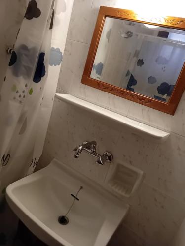 a bathroom with a sink and a mirror at Studio Lemoni Peloponnese in Pirgákion