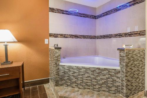 a bathroom with a tub in a room at Quality Inn Janesville North in Janesville