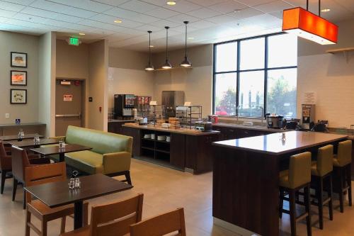 a restaurant with tables and chairs and a cafeteria at Country Inn & Suites by Radisson, San Jose International Airport, CA in San Jose