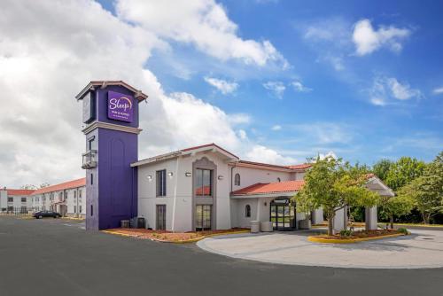 a building with a purple tower with a sign on it at Sleep Inn & Suites Merrillville in Merrillville