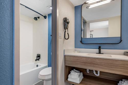 a bathroom with a sink and a mirror at Sleep Inn & Suites Merrillville in Merrillville