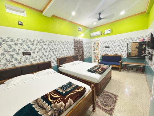 a room with two beds and a couch in it at HOLIDAY INN in Konārka
