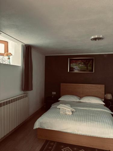 a bedroom with a large bed with white sheets at Casa Rariana in Călimăneşti
