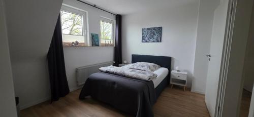 a small bedroom with a bed and a window at Ferienwohnung bei Natie in Brilon