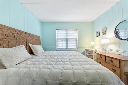 a bedroom with a bed and a desk and a window at Surfside Getaway with Heated Pool & BBQ Grill in North Wildwood