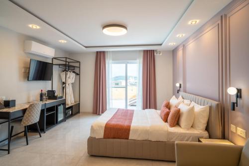 a bedroom with a bed and a desk and a kitchen at Pietro Boutique Hotel and Villas in Għarb