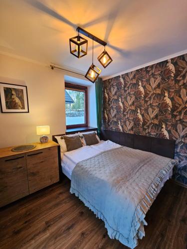 a bedroom with a large bed and a window at U Efci in Kościelisko