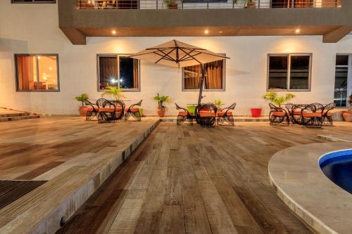 an empty dance floor with tables and chairs at The Palms by Eagles in Takoradi