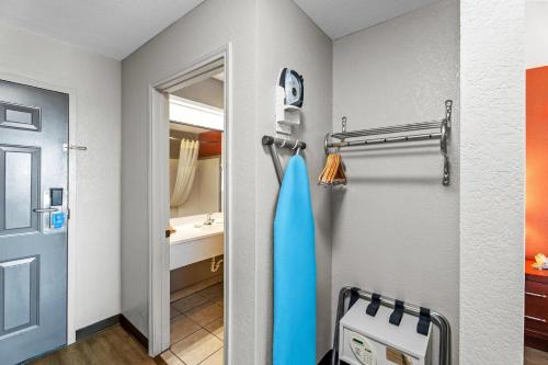 a room with a bathroom with a door and a sink at Rodeway Inn in Temple