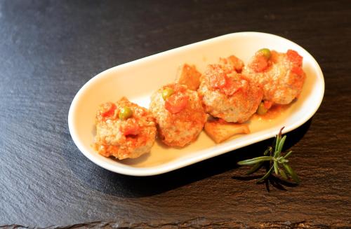 a plate of food with shrimp on a table at Barri Antic Hostel & Pub in Andorra la Vella