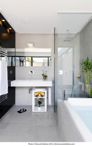 a bathroom with a white tub and a sink and a shower at Sezz Saint-Tropez in Saint-Tropez