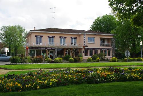 a house with a flower garden in front of it at Hotel L'Ecureuil in Saint-Paul-en-Born