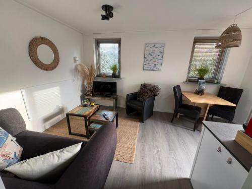 a living room with a couch and a table at Waves in De Koog