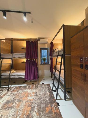 a room with two bunk beds and a table at TWENTY Hostel in Samarkand
