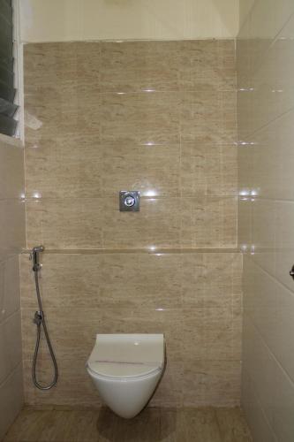 a bathroom with a toilet and a camera on the wall at Amar Resorrt in Motīhāri