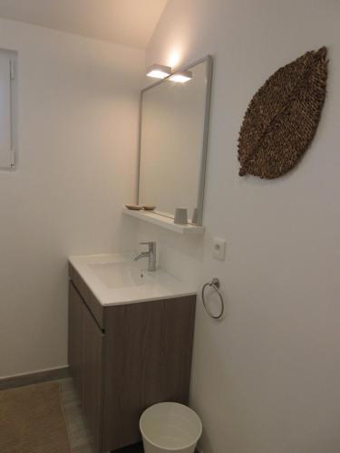 a bathroom with a sink and a mirror and a toilet at La tour de Plumont in Dole