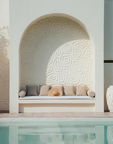 a bench in a room with a wall at Salt & Palm Villa in Maggona West