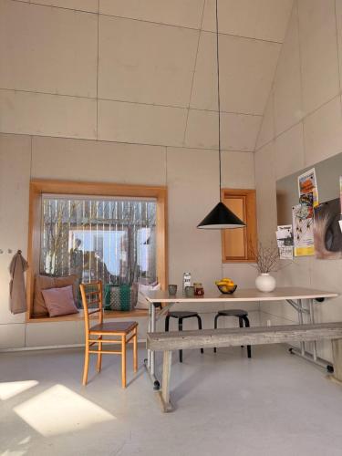 a living room with a table and chairs and a dining room at 44Møen in Askeby