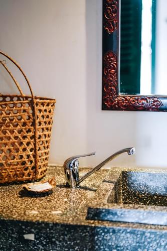 a bathroom counter with a sink and a basket on it at Golden Banana Residence in Siem Reap