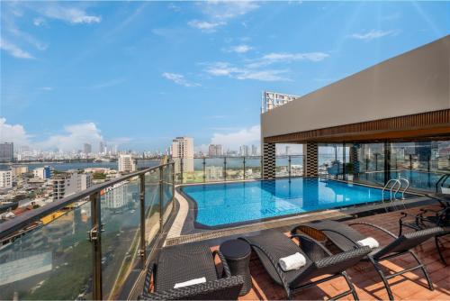 a balcony with a swimming pool on top of a building at Mitisa Hotel Da Nang - Near Dragon Bridge in Danang