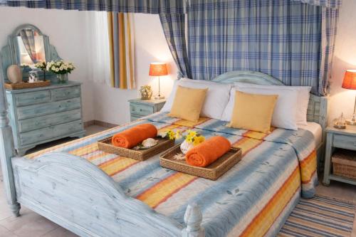 a bedroom with a bed with two baskets on it at Beach Shack in Khlorakas