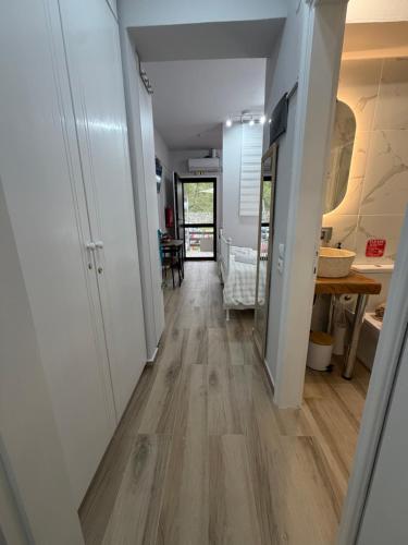 a hallway of a house with white walls and wood floors at The Small apartment Papa Nero Pelion in Agios Ioannis Pelio