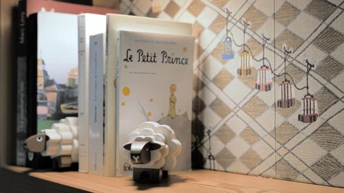 a book sitting on a shelf next to other books at Hôtel La Bergerie in Morzine