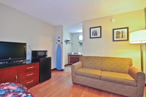 a living room with a couch and a flat screen tv at Country Hearth Inn & Suites Marietta in Atlanta