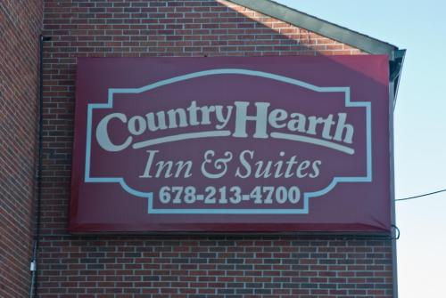 a sign on the side of a brick building at Country Hearth Inn & Suites Marietta in Atlanta