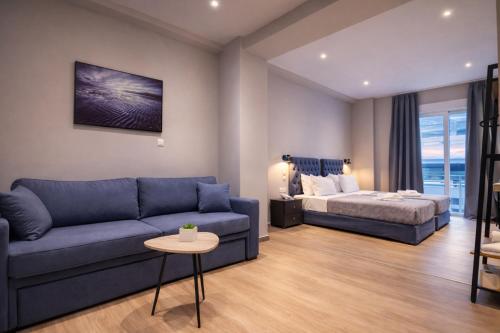a living room with a couch and a bed at New Amaryllis Hotel in Athens