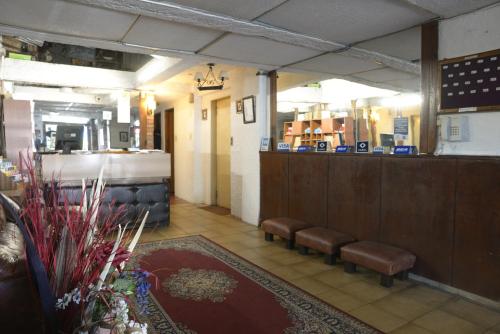 a waiting room with benches and a bar in a store at Hotel Gaviota in Montevideo
