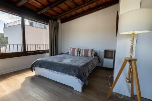 a bedroom with a bed and a large window at Seamount, studio 3 mins from Tamariu beach in Tamariu